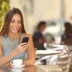 girl-texting-on-the-smart-phone-in-a-restaurant